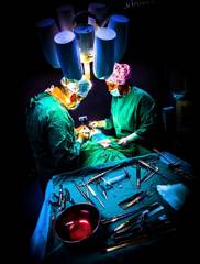 Dr Ioannis Liapakis and surgical team performing cosmetic surgery in the operating room