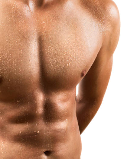 Close-up of fit male chest and abdomen after gynecomastia surgery showing natural, defined contour