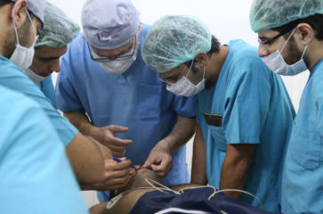 Reconstructive surgery team performing procedure