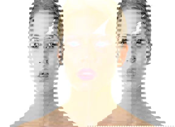 Portrait of woman peeling away old skin layer like paper to reveal smoother new skin underneath