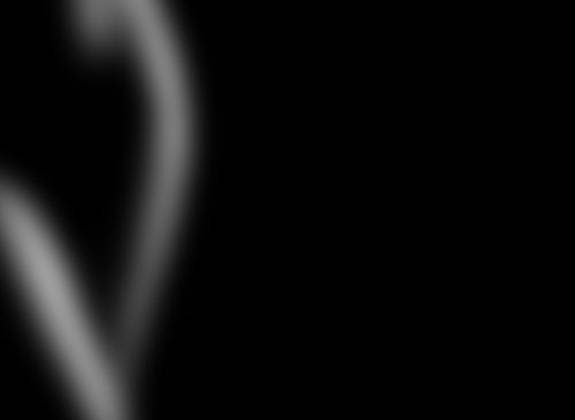 Abstract blurred image of a silhouette against a dark background