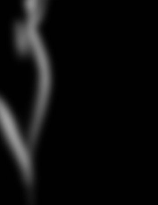 Abstract blurred image of a silhouette against a dark background