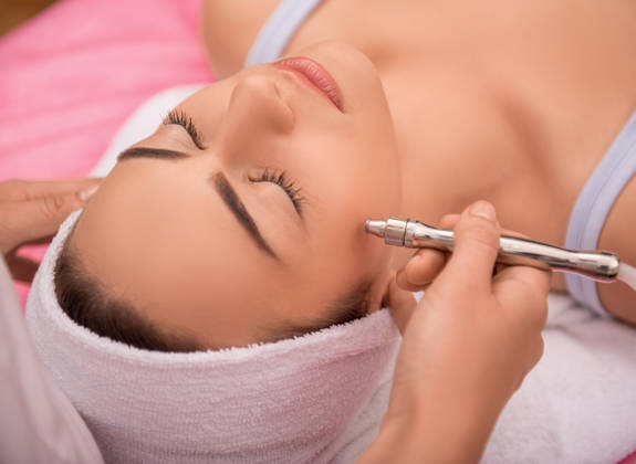 Facial treatment using a microdermabrasion wand