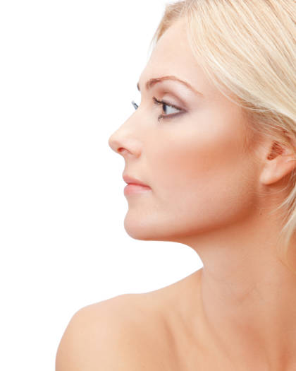 Profile portrait of a blonde woman with smooth skin and balanced nose shape after rhinoplasty
