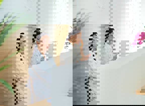 Receptionists welcoming patients at Opsis Clinical