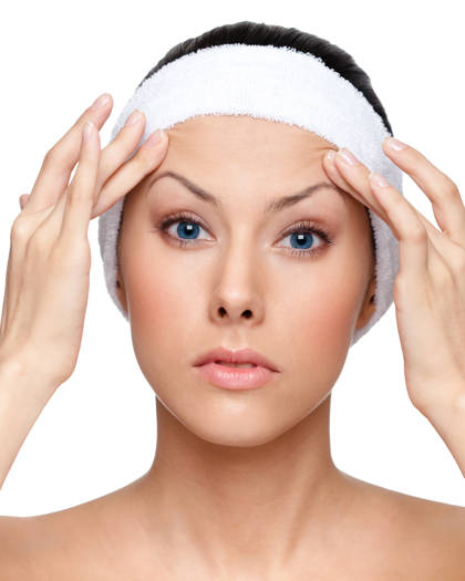 Portrait of a woman gently lifting her eyebrows, demonstration the upper face region 