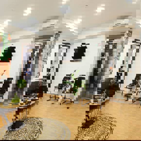 Cozy waiting area with modern decor and artwork at Opsis Clinical