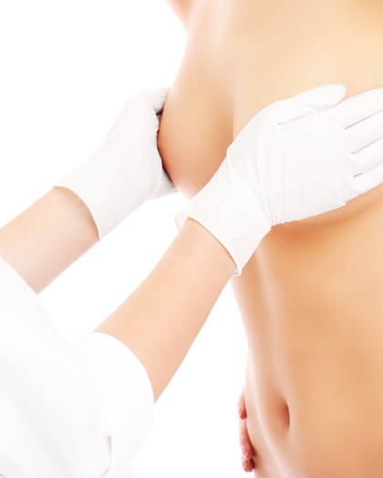 Plastic surgeon examining breast before lift procedure